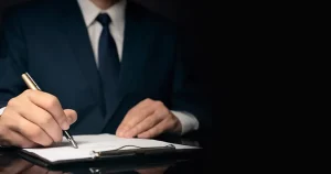 man in a suit writing