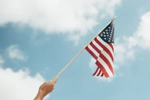 refugee holding and waving a US flag
